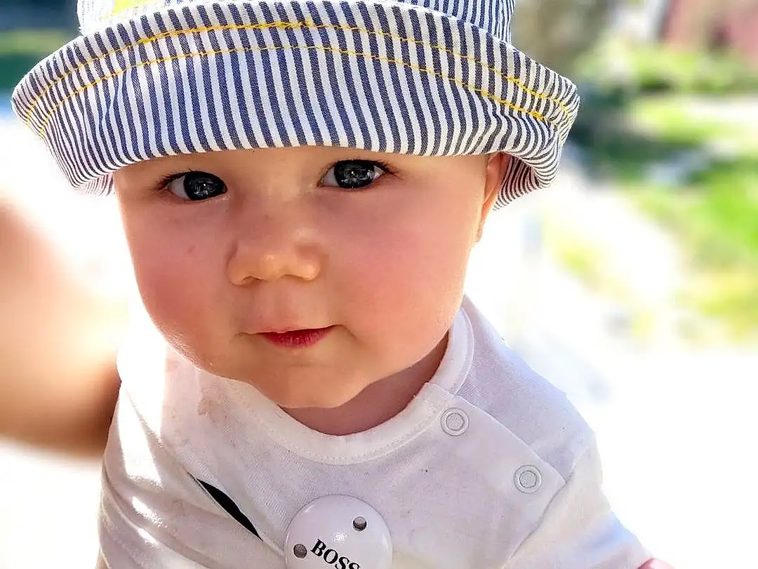 Chapi Chapo, Photograph, Blanc, Sun Hat, Baby & Toddler Clothing, Sleeve, Cap, Baby, Yellow, Happy, Cool, Bambin, Headgear, Summer, People In Nature, Herbe, Fun, Beauty, Enfant, Leisure, Personne, Headwear