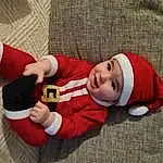 Sourire, Sleeve, Baby & Toddler Clothing, Headgear, Comfort, Bambin, Baby, Santa Claus, Enfant, Lap, Holiday, Sock, NoÃ«l, Carmine, Cap, Fictional Character, Room, Christmas Eve, Fun, Personne, Headwear